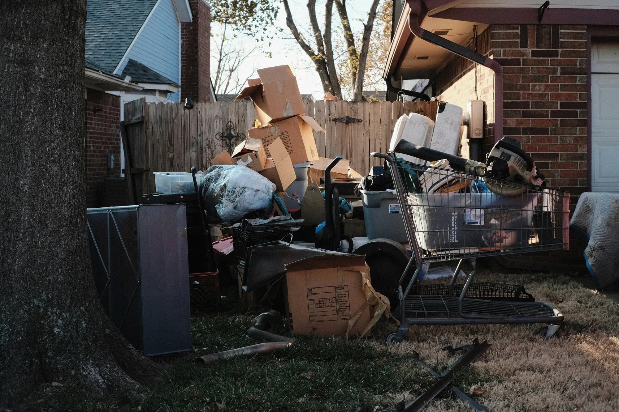 Pile of boxes and household items outside a house